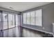 Bright living room with hardwood floors, large windows, and sliding glass door to balcony at 226 Queens Rd # 68, Charlotte, NC 28204