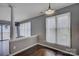 Bright living room with hardwood floors, large windows, and modern lighting fixture at 226 Queens Rd # 68, Charlotte, NC 28204