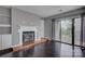 Cozy living room with fireplace, hardwood floors, and sliding door to balcony at 226 Queens Rd # 68, Charlotte, NC 28204