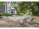 Condo community pool featuring lounge chairs and gazebo for residents to enjoy at 226 Queens Rd # 68, Charlotte, NC 28204