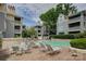 Community pool area features a pool, lounge chairs, grilling area and condo buildings at 226 Queens Rd # 68, Charlotte, NC 28204