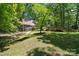 The lush backyard offers a peaceful retreat with a hammock, mature trees, and a spacious deck for outdoor living at 2507 Connemara Dr, Matthews, NC 28105