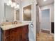 Bathroom features a decorative vanity with cabinet storage, unique glass window and tiled floors at 2507 Connemara Dr, Matthews, NC 28105