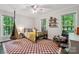 bedroom with fun star ceiling, black spindle bed, chair swing, hardwood floors and bright windows at 2507 Connemara Dr, Matthews, NC 28105