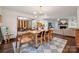 Bright dining room with hardwood floors, modern chandelier, and seamless open flow to the living spaces at 2507 Connemara Dr, Matthews, NC 28105