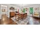 Sunlit dining room featuring hardwood floors, vintage furniture, and natural light from the windows at 2507 Connemara Dr, Matthews, NC 28105