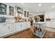 Bright kitchen with white cabinets, stainless appliances, hardwood floors and an island with storage at 2507 Connemara Dr, Matthews, NC 28105