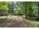 Backyard playground with swing set, surrounded by mature trees, offering a fun and safe play area at 2507 Connemara Dr, Matthews, NC 28105
