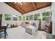 Cozy sunroom with vaulted ceilings, tile floors, comfortable seating, and ample natural light at 2507 Connemara Dr, Matthews, NC 28105