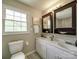 Bathroom with double sinks, cabinets, vanity, and neutral wall colors at 2666 Hill Ln, Gastonia, NC 28054