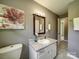 Neutral bathroom with granite countertops, vanity, and decorative mirror at 2666 Hill Ln, Gastonia, NC 28054