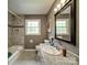 Bathroom with granite countertops, tiled flooring, tub and shower combo at 2666 Hill Ln, Gastonia, NC 28054