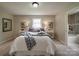 Serene bedroom with decor, including a queen bed and tables, adjacent to a bathroom at 2666 Hill Ln, Gastonia, NC 28054