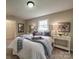 Cozy bedroom with a queen bed, soft carpet, side tables and lamps, and elegant decor at 2666 Hill Ln, Gastonia, NC 28054