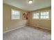 Neutral carpeted bedroom with three windows providing abundant natural light at 2666 Hill Ln, Gastonia, NC 28054