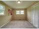 Comfortable carpeted bedroom with 2 windows and a closet at 2666 Hill Ln, Gastonia, NC 28054