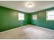 Bedroom features green walls, carpet flooring, and a window with natural light at 2666 Hill Ln, Gastonia, NC 28054