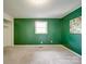 Bedroom features bright green wall, and neutral carpet and trim at 2666 Hill Ln, Gastonia, NC 28054