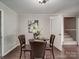 Dining room with a table set for four people, an adjacent staircase, and a painting at 2666 Hill Ln, Gastonia, NC 28054