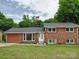 Charming brick two-story home with landscaped yard and a welcoming white front door, offering great curb appeal at 2666 Hill Ln, Gastonia, NC 28054