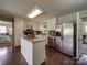 Functional kitchen with white cabinetry, stainless steel appliances, and an island, offering both style and practicality at 2666 Hill Ln, Gastonia, NC 28054