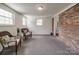 Living room has two wicker chairs, and a brick wall accent at 2666 Hill Ln, Gastonia, NC 28054