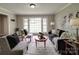 Comfortable living room with hardwood floors and large windows, providing natural light and a serene atmosphere at 2666 Hill Ln, Gastonia, NC 28054