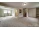The living room features space to gather, carpet flooring and lots of light at 2666 Hill Ln, Gastonia, NC 28054
