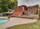 View of the home exterior featuring the pool area and back deck at 2666 Hill Ln, Gastonia, NC 28054