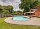 Large backyard with a fenced-in pool, patio, and lush greenery at 2666 Hill Ln, Gastonia, NC 28054