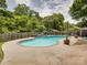 Backyard oasis featuring a kidney shaped swimming pool, fence, and lounge area at 2666 Hill Ln, Gastonia, NC 28054