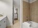 A bathroom with a tub-shower combo and neutral tile, easily accessible from the vanity area at 300 W 5Th St # 433, Charlotte, NC 28202