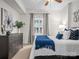Well-lit bedroom with a neutral color palette, soft carpet, and a view of the outside through a window at 300 W 5Th St # 433, Charlotte, NC 28202