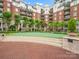 Multi-story condo building with manicured landscaping surrounding a green putting-range at 300 W 5Th St # 433, Charlotte, NC 28202