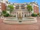 Serene fountain in common area, with landscaped greenery and brick pavers, offering a peaceful outdoor space for residents at 300 W 5Th St # 433, Charlotte, NC 28202