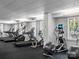 Well-lit fitness center with an array of cardio equipment and exercise machines for residents at 300 W 5Th St # 433, Charlotte, NC 28202
