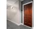 Condo 433 with a solid door, neutral walls, and updated hallway lighting and carpet, offering a quiet entry at 300 W 5Th St # 433, Charlotte, NC 28202