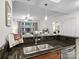 Open kitchen featuring granite countertops, stainless steel sink, and a breakfast bar with seating to a living area at 300 W 5Th St # 433, Charlotte, NC 28202