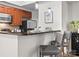Stylish kitchen featuring stainless steel appliances, wood cabinets, a breakfast bar with seating, and modern decor at 300 W 5Th St # 433, Charlotte, NC 28202