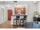 Cozy kitchen featuring wood cabinets, a breakfast bar with barstools, and an open layout to a living area at 300 W 5Th St # 433, Charlotte, NC 28202