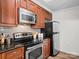 Updated kitchen featuring stainless steel appliances, granite counters, and hardwood floors, perfect for cooking and entertaining at 300 W 5Th St # 433, Charlotte, NC 28202