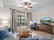 Comfortable living room with a sliding glass door to the balcony and entertainment center at 300 W 5Th St # 433, Charlotte, NC 28202