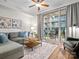Bright living room featuring a plush sofa and balcony access, perfect for relaxing or entertaining at 300 W 5Th St # 433, Charlotte, NC 28202