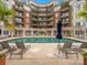 Relaxing pool area with lounge chairs, palm trees, and a luxurious condo building as backdrop at 300 W 5Th St # 433, Charlotte, NC 28202