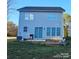 Spacious backyard featuring a patio, sliding glass doors, and grassy lawn at 320 Lawrence Gray Rd, Charlotte, NC 28262