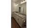 Bathroom featuring an extended vanity with double sinks, granite countertop, and dark bronze fixtures at 320 Lawrence Gray Rd, Charlotte, NC 28262