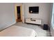 Bedroom with a view to the bathroom, a TV, and modern furniture on neutral carpeting at 320 Lawrence Gray Rd, Charlotte, NC 28262