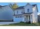 Charming two-story home with vinyl siding, a welcoming front porch, and an attached garage at 320 Lawrence Gray Rd, Charlotte, NC 28262