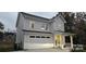 Charming two-story home with a neutral exterior, attached garage, and well-maintained front yard at 320 Lawrence Gray Rd, Charlotte, NC 28262