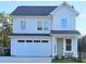 Charming two-story home with a white facade, attached garage, and well-maintained landscaping at 320 Lawrence Gray Rd, Charlotte, NC 28262